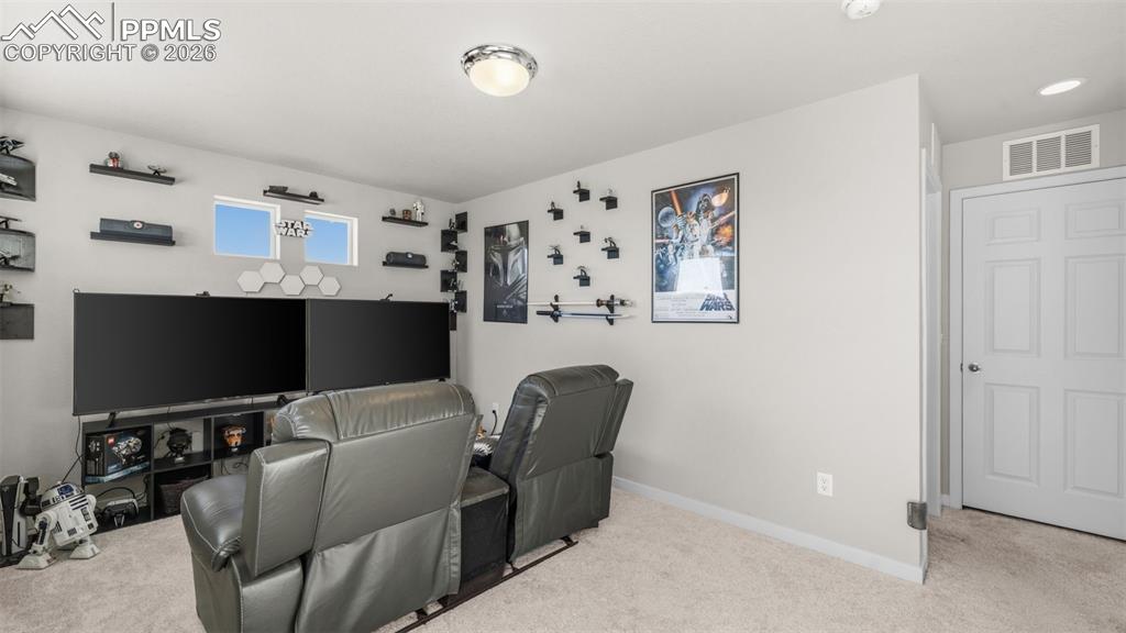 Image 16 of 37: Cinema featuring light carpet and baseboards