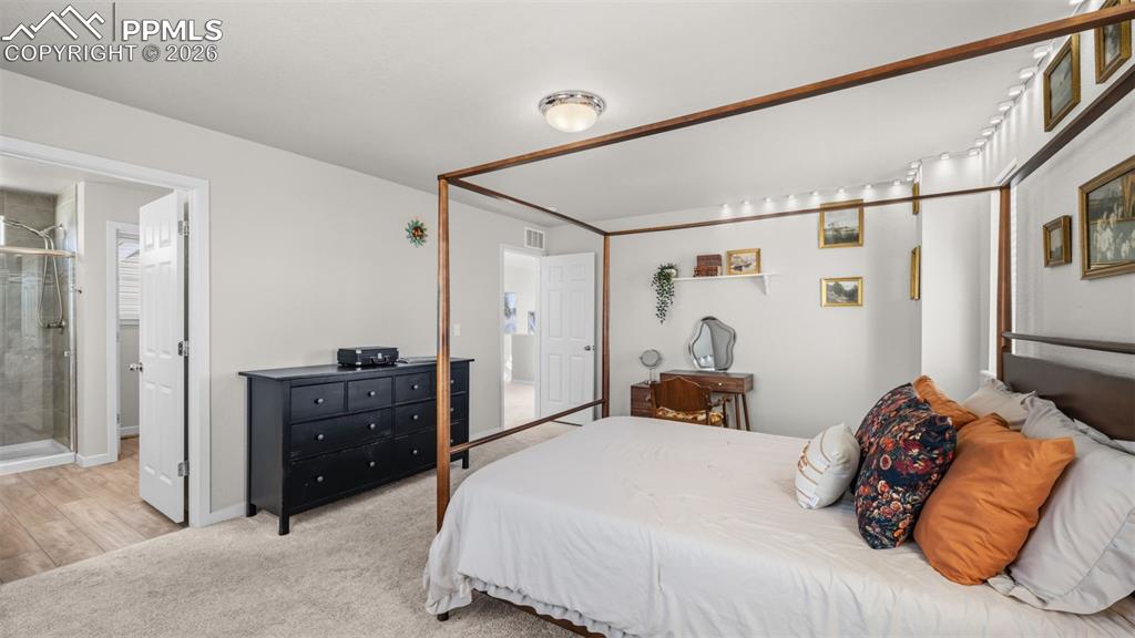 Image 23 of 37: Bedroom with light colored carpet