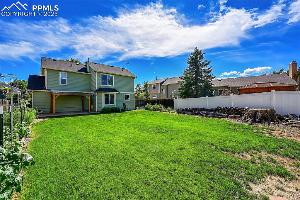 Image 36 of 39: Rear view of house with a patio, a fenced backyard, and a residential view
