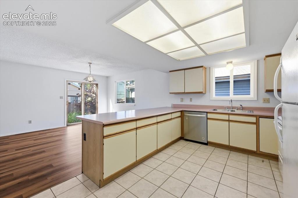 Image 10 of 26: Kitchen with dining space and a sliding door to the patio at , Colorado Spr