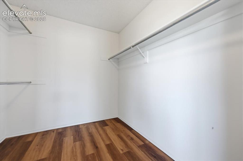 Image 13 of 26: Large primary suite walk-in closet with built-in shelving at , Colorado Spr