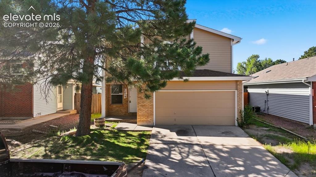 Image 22 of 26: Daytime curb appeal with mature pine trees at , Colorado Springs, CO.