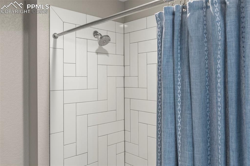 Image 27 of 33: Decorative tile in shower and bathroom floor in 2nd Full bathroom 
