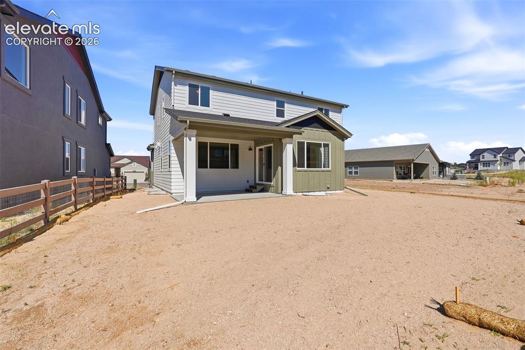 Image 47 of 50: The Covered Rear Patio walks out to a spacious backyard!