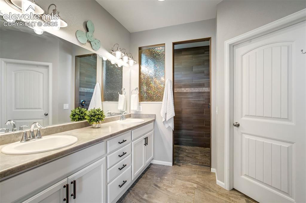 Image 19 of 46: Dual sinks and enough space for your 32 step skincare routine.