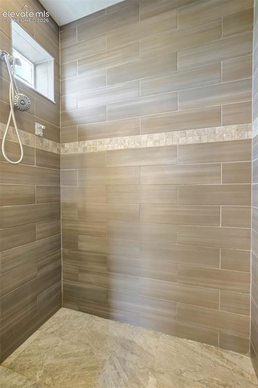 Image 20 of 46: Walk-in shower with a window.