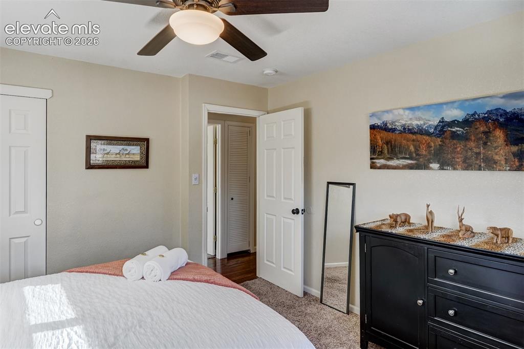 Image 15 of 43: Ceiling fan with integrated lighting, textured carpeting, and white interio