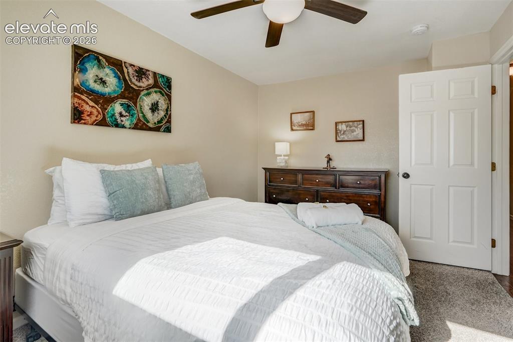 Image 18 of 43: Neutral wall tones complement the ceiling fan with integrated lighting, woo