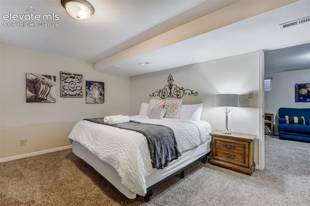 Image 30 of 43: Carpeted flooring throughout, recessed ceiling light fixture, and a decorat