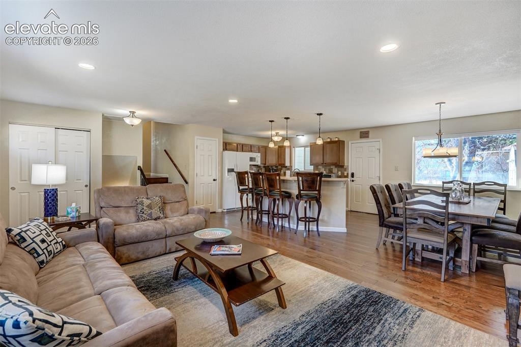 Image 8 of 43: Hardwood flooring, recessed lighting, kitchen island with seating, pendant