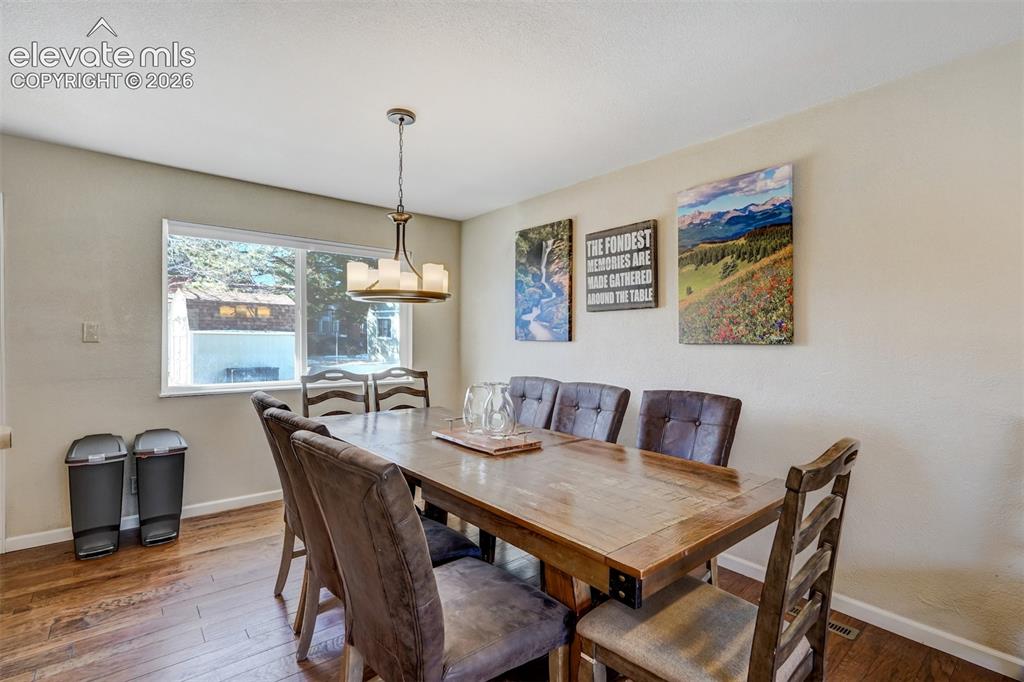 Image 9 of 43: Hardwood flooring, painted walls, window with trim, and a ceiling-mounted l