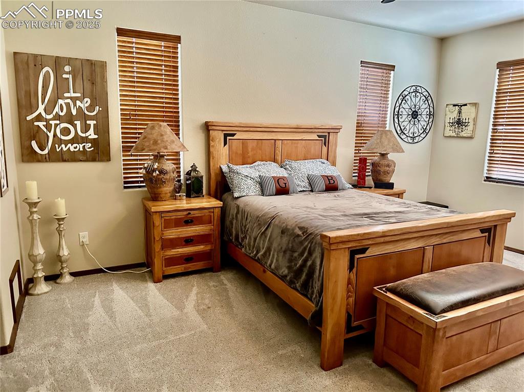 Image 14 of 33: Bedroom featuring baseboards and light colored carpet