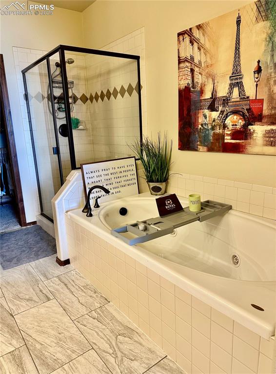 Image 16 of 33: Full bath with a stall shower and a tub with jets