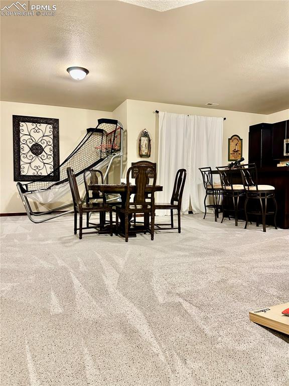 Image 20 of 33: Carpeted dining area featuring a textured ceiling