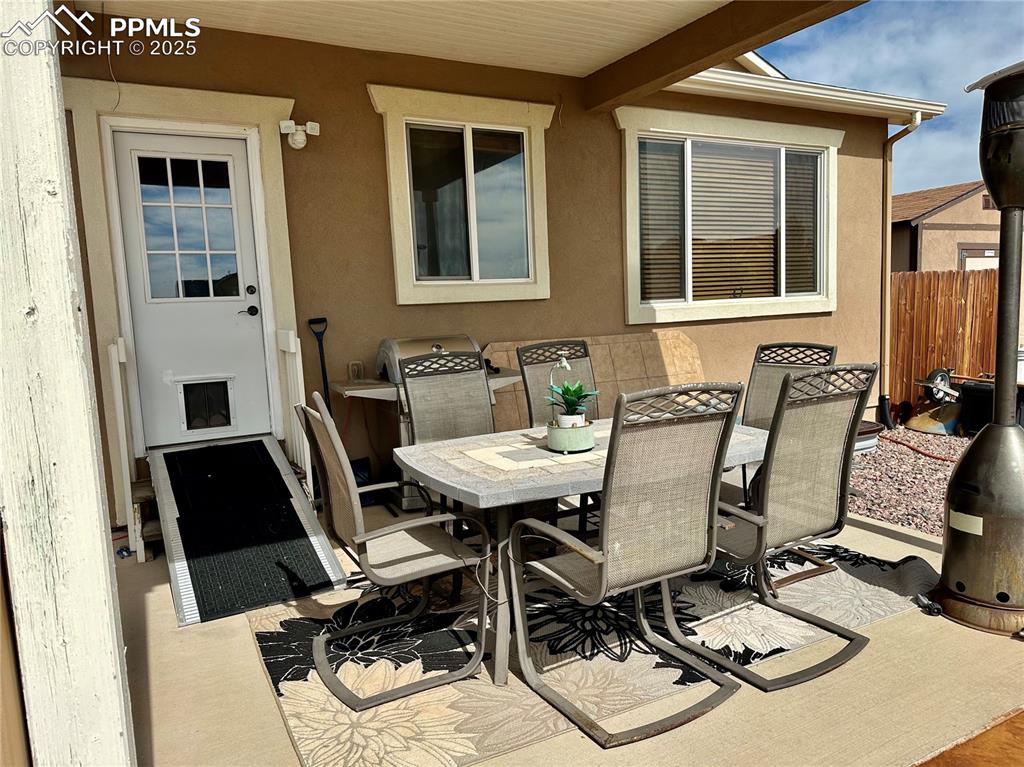 Image 32 of 33: View of patio with outdoor dining space and area for grilling
