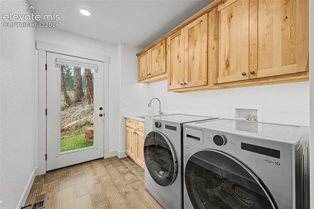 Image 21 of 50: Main level laundry, with exit to side yard