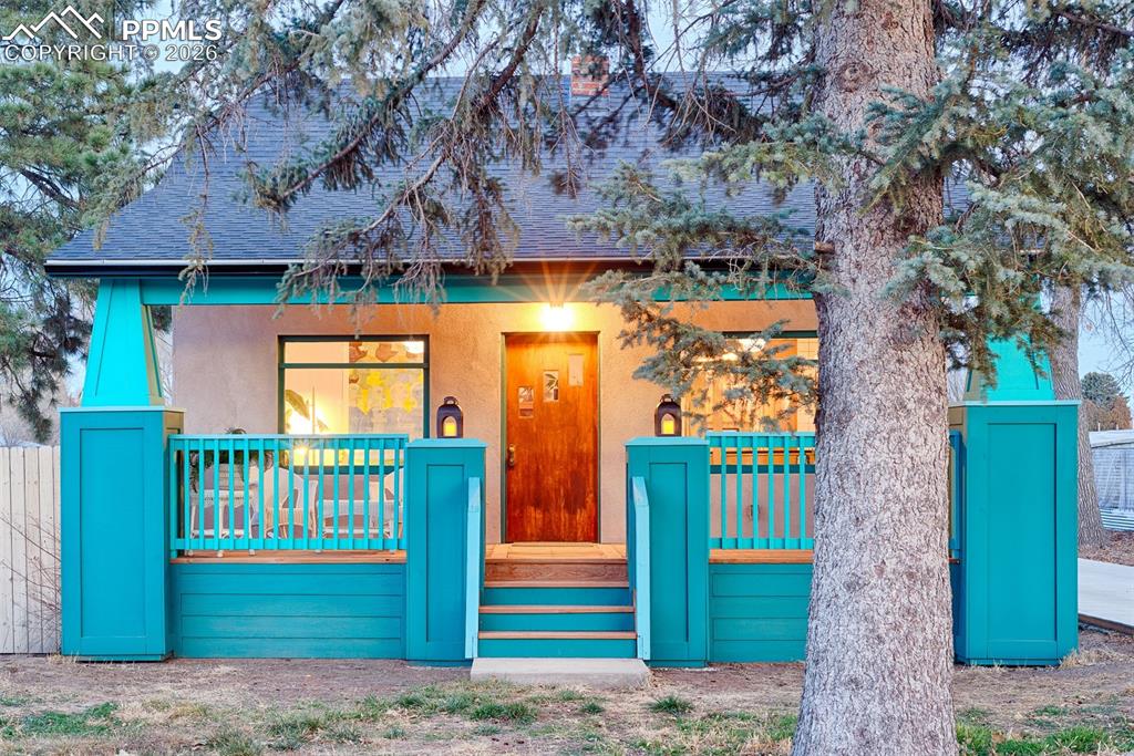 Caption: Front of the home at dusk with new built Craftsman style porch