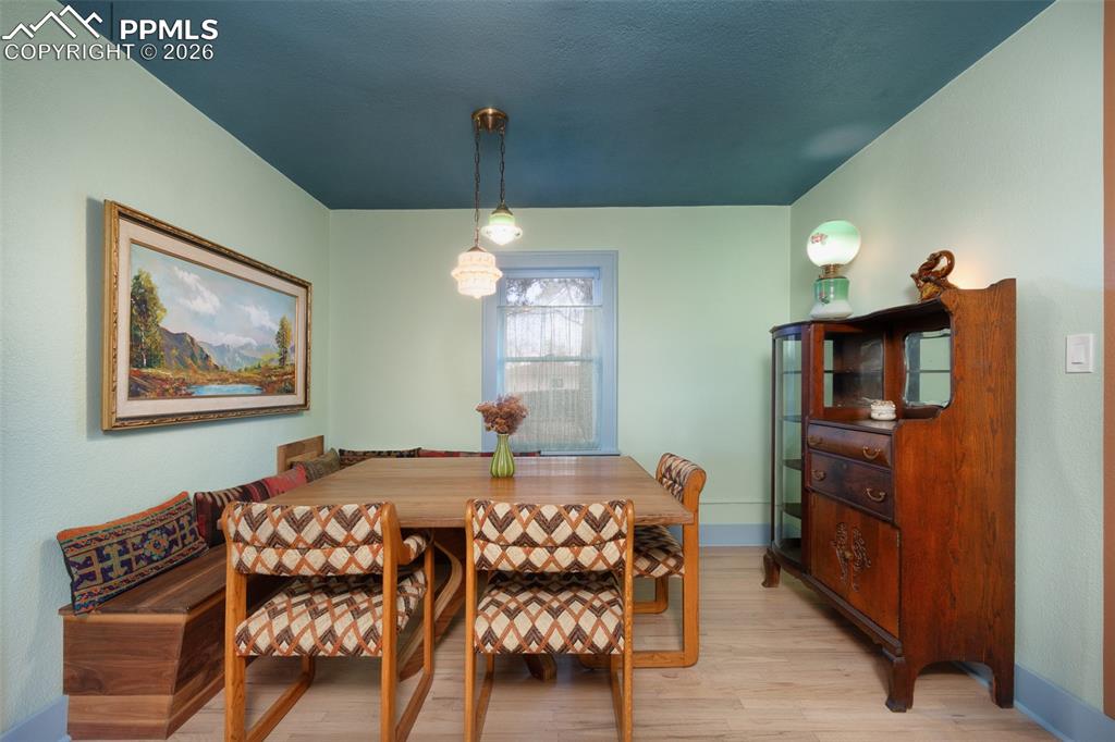 Image 14 of 50: Dining room with custom built dining table and built in bench that will sta