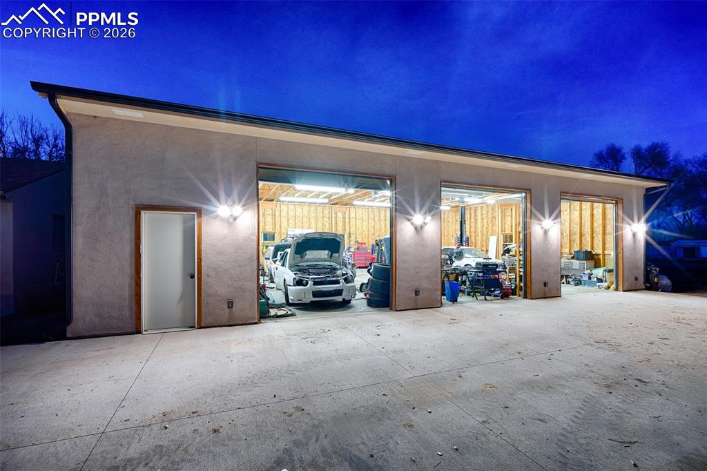 Image 2 of 50: Oversized garage and workshop for 6 cars or 3 RVs, car lift included!