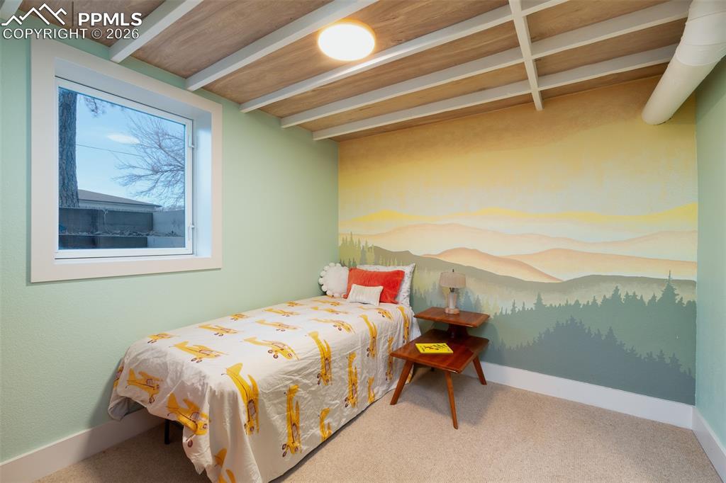 Image 23 of 50: One of two basement bedrooms with hand painted mural and egress window