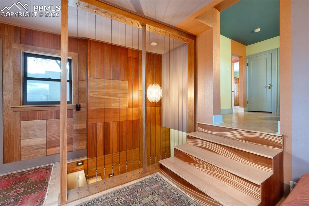 Image 4 of 50: Custom wood paneling, custom wood stairs and room separator with vintage fi
