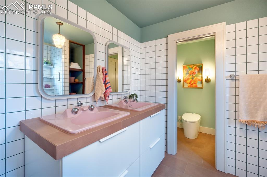 Image 5 of 50: Ensuite primary bathroom, fully remodeled. Separate water closet with Japan