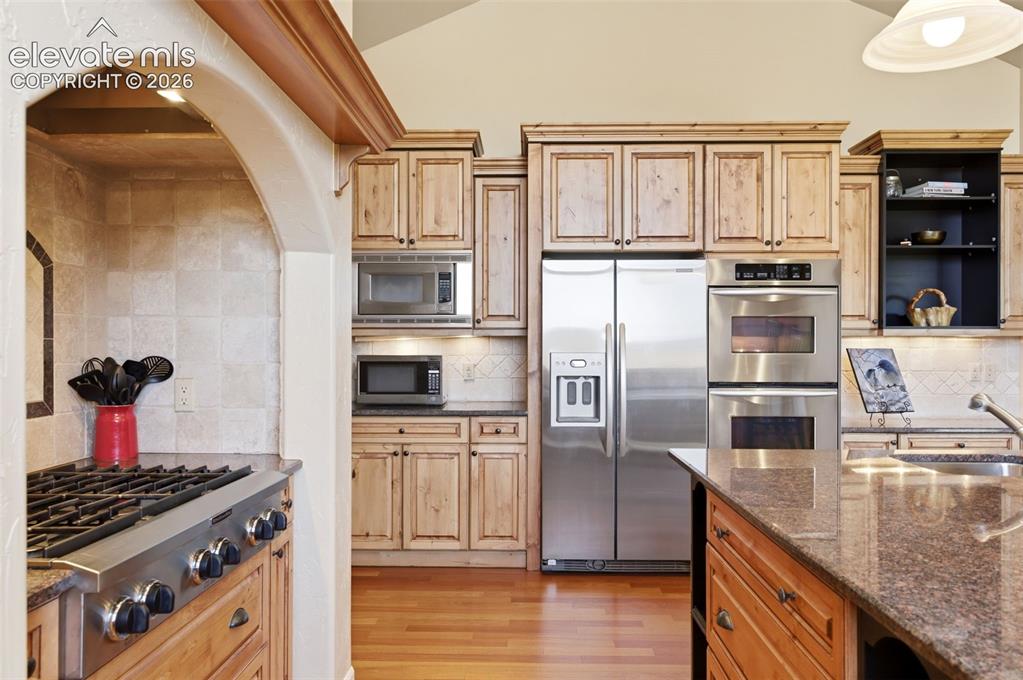 Image 2 of 50: Kitchen featuring wood cabinetry, stainless steel appliances, a built-in do