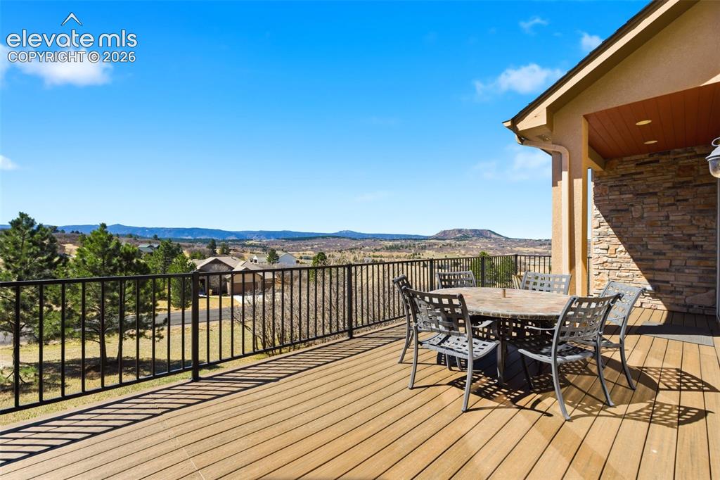 Image 21 of 50: Expansive outdoor deck featuring wood-finish flooring and black metal raili