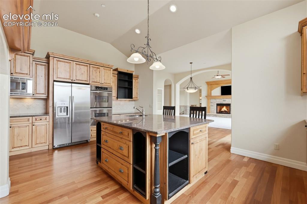 Image 24 of 50: Spacious kitchen featuring an expansive center island with seating, stainle