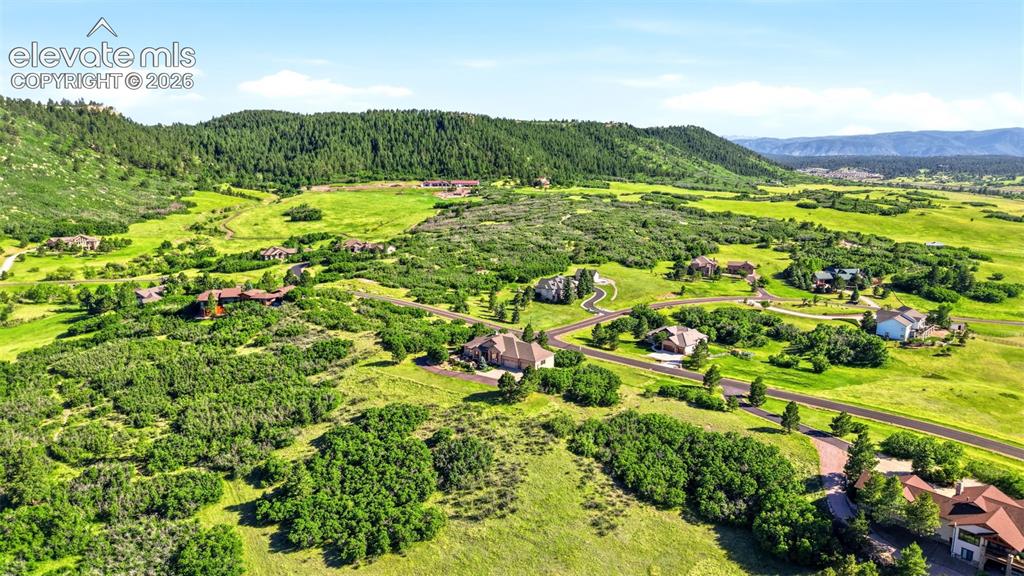 Image 50 of 50: Expansive green landscape with scattered residential properties, bordered b