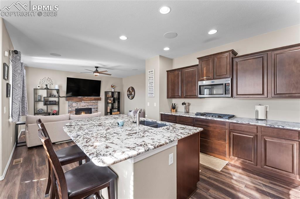 Image 7 of 50: Never miss a moment of the game/movie/binge series with this open kitchen/l