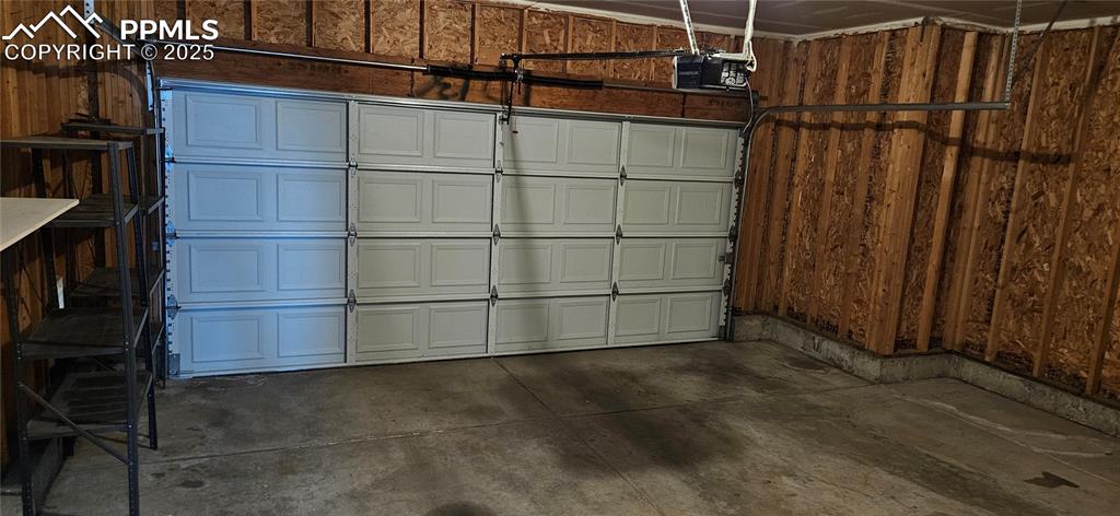 Image 26 of 26: Garage with a garage door opener