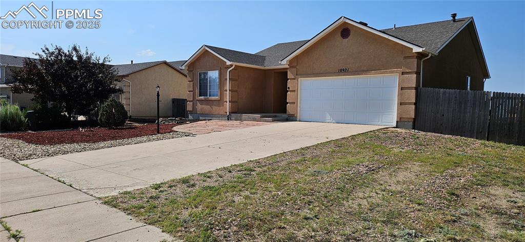 Image 3 of 26: Single story home with stucco siding, concrete driveway, and a garage