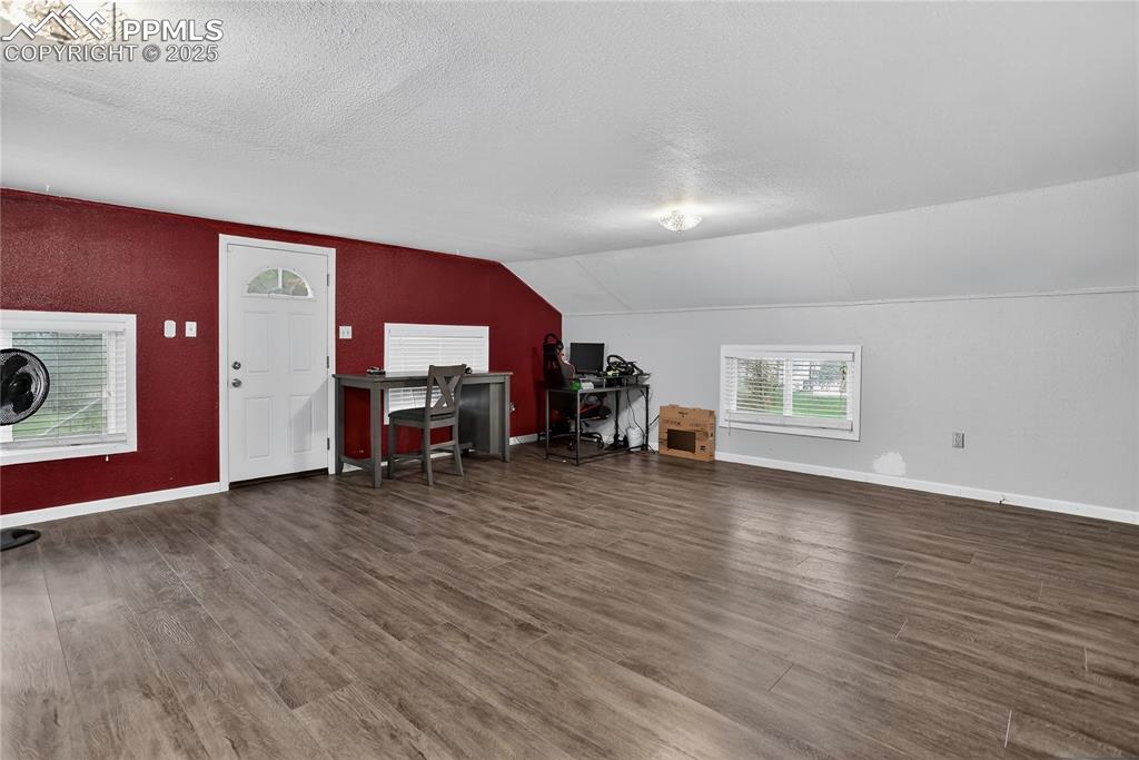 Image 22 of 50: This family room adjoins a kitchen