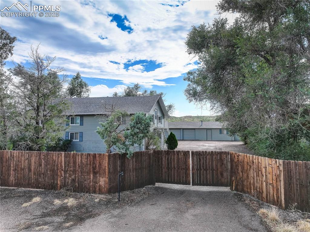Image 26 of 50: The property sits behind a privacy fence