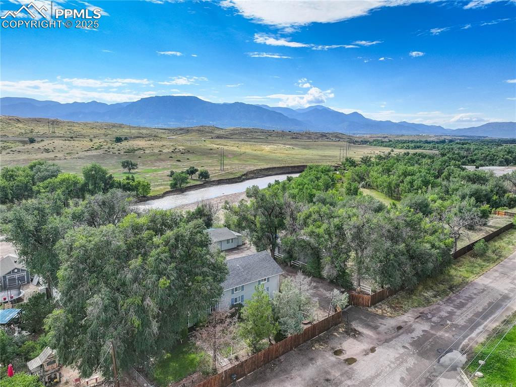 Image 3 of 50: View of mountain backdrop with a nearby body of water and rural landscape