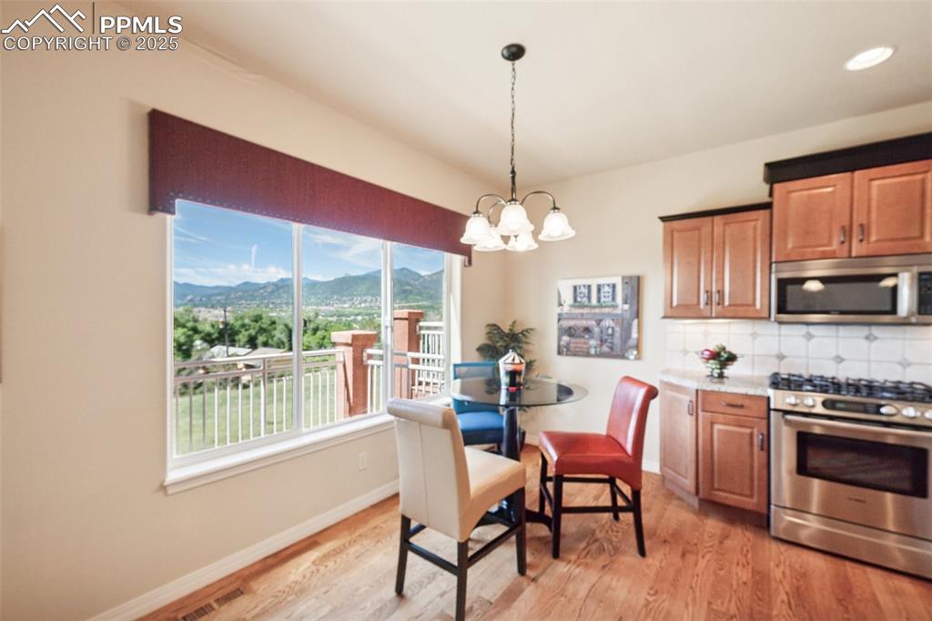 Image 13 of 47: Kitchen featuring appliances with stainless steel finishes, a chandelier, a