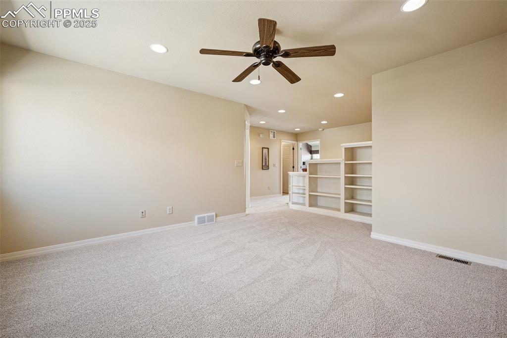 Image 23 of 47: Empty room with ceiling fan, recessed lighting, and light carpet