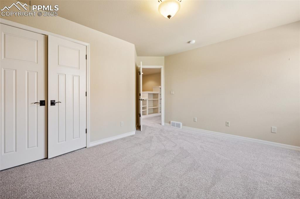 Image 26 of 47: Unfurnished bedroom featuring carpet flooring and baseboards