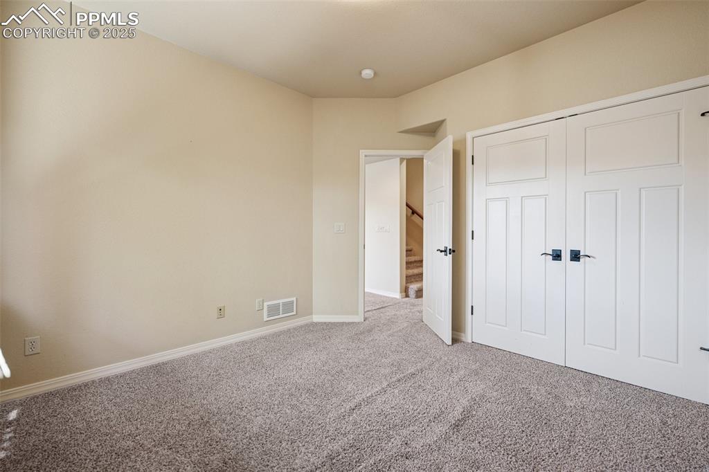 Image 31 of 47: Unfurnished bedroom with carpet and a closet