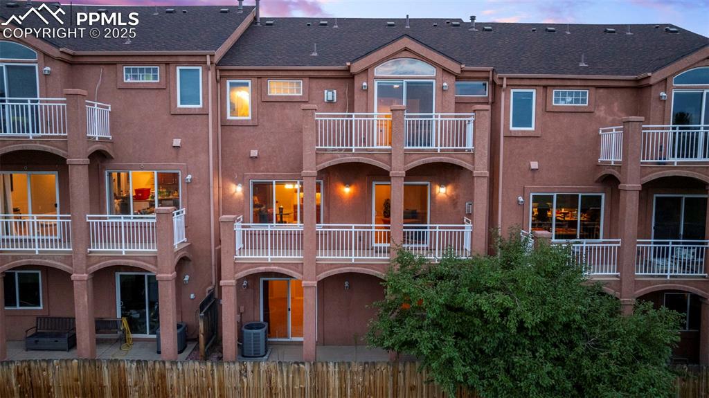 Image 35 of 47: Back of house featuring stucco siding, a balcony, a patio area, and roof wi