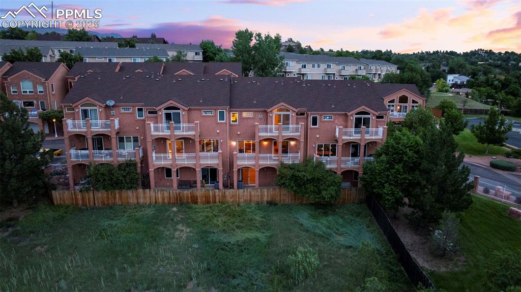 Image 37 of 47: View of property at dusk