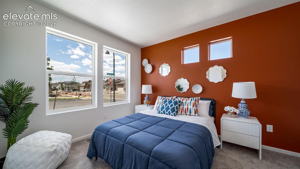 Image 6 of 26: Dual pane windows, accent wall, wall-to-wall carpeting, and a built-in elec