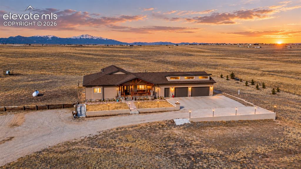 Image 1 of 49: Stucco exterior with a covered front porch, integrated two-car garage, and