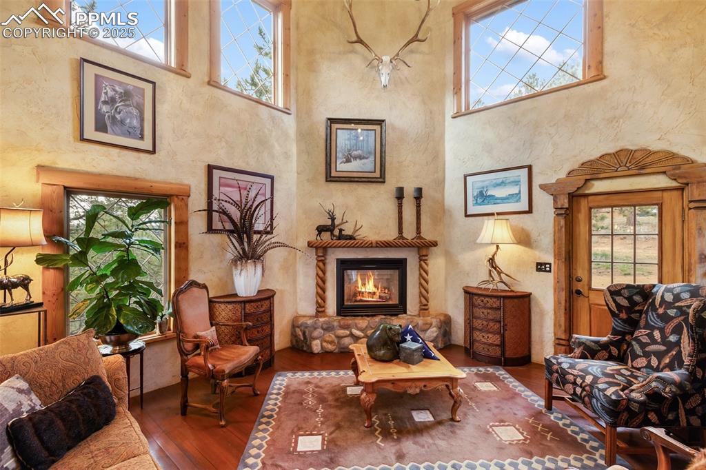 Image 12 of 50: Living area with hardwood / wood-style floors, healthy amount of natural li