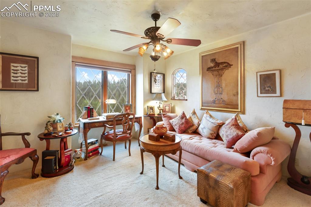 Image 27 of 50: Carpeted living area featuring ceiling fan