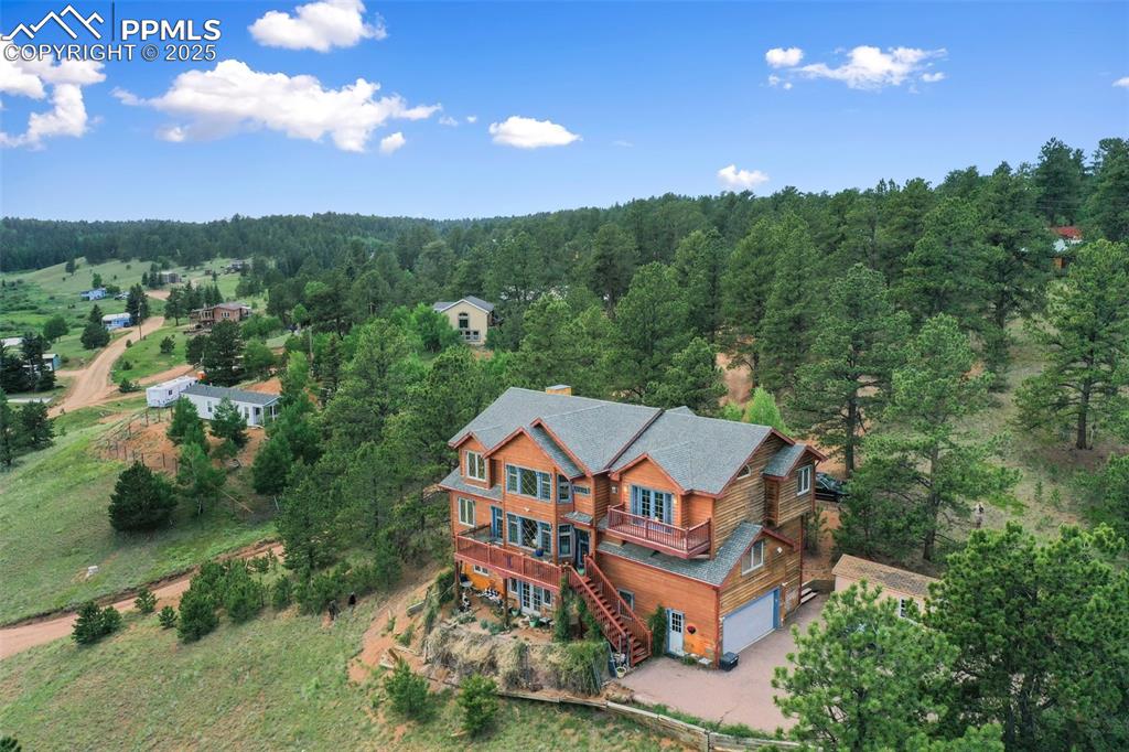 Image 3 of 50: View from above of property featuring a forest