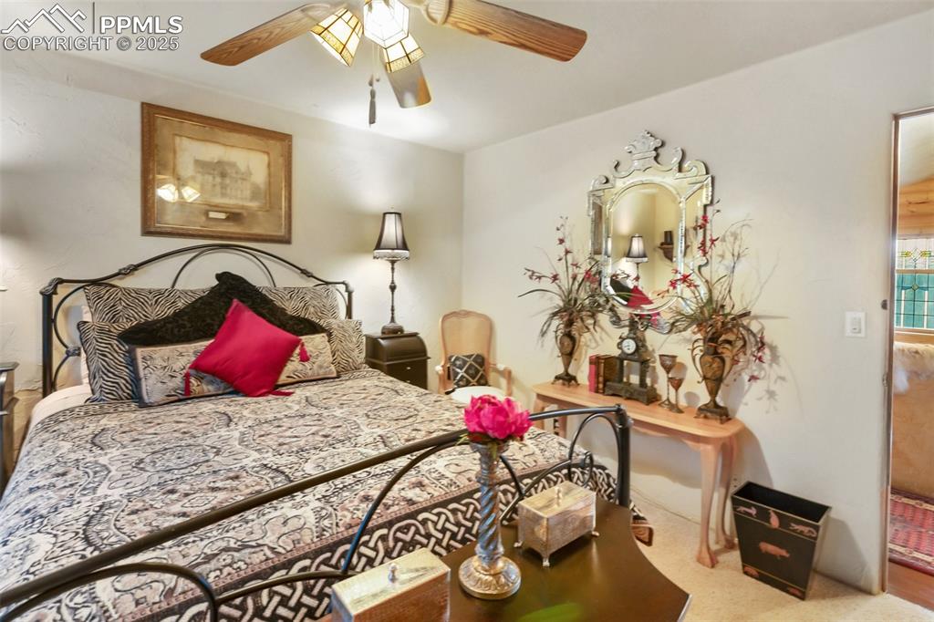 Image 32 of 50: Bedroom with a ceiling fan and carpet