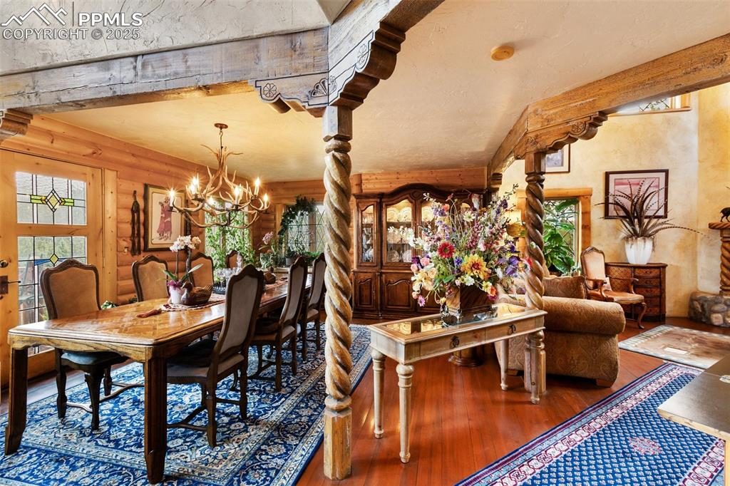 Image 9 of 50: Dining area with hardwood / wood-style floors and a chandelier