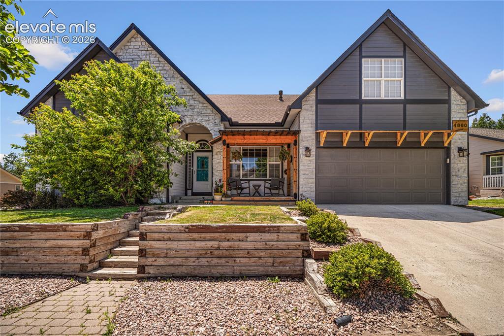 Image 1 of 50: Stone and siding exterior with gabled roof lines